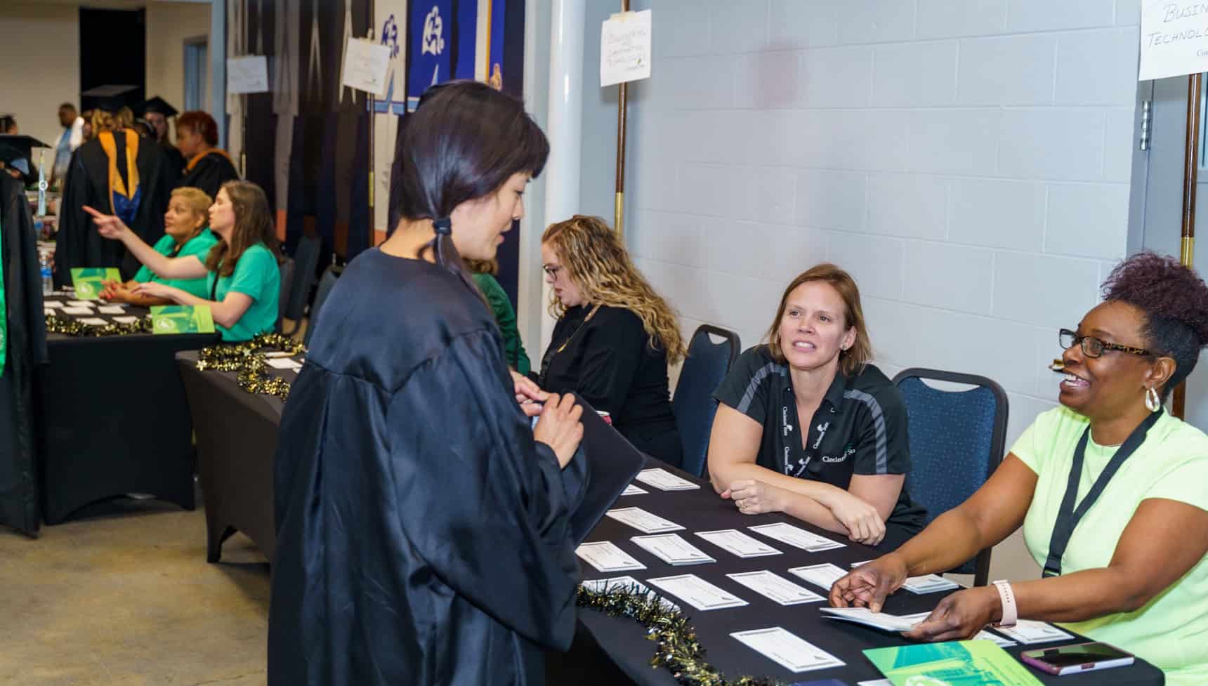 College staff members helped graduates check-in and prepare for the ceremony